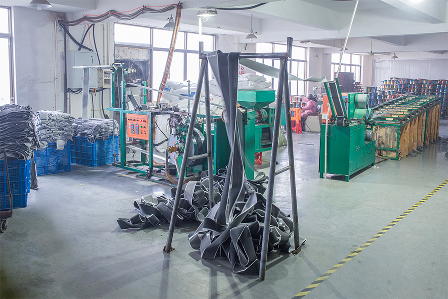 Weatherstrip workshop with production equipment and material bins