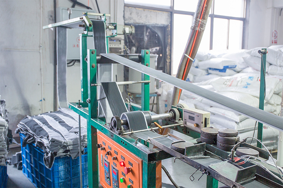 Weatherstrip production machine with pile material beside the line