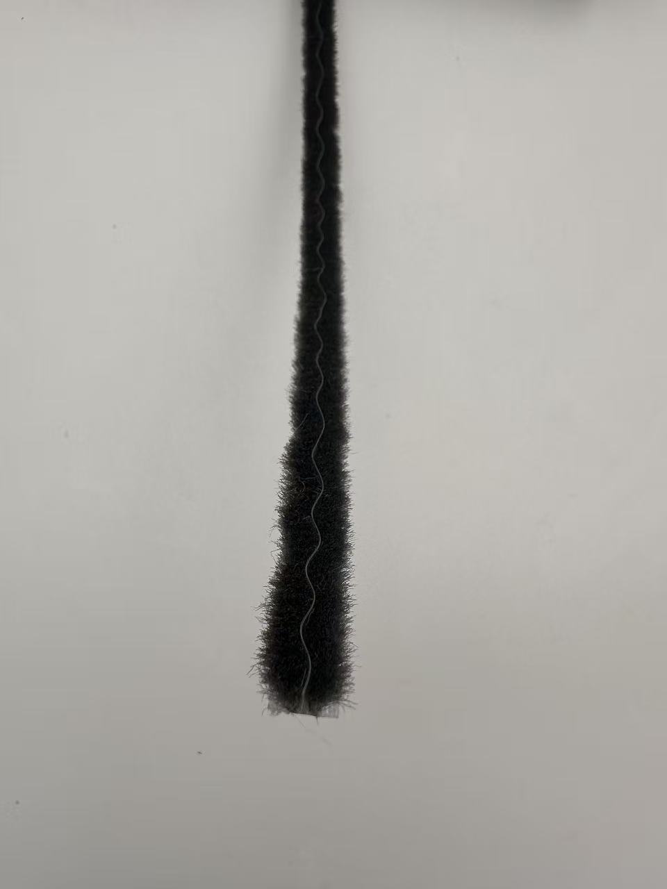 Black door brush strip material on a white background