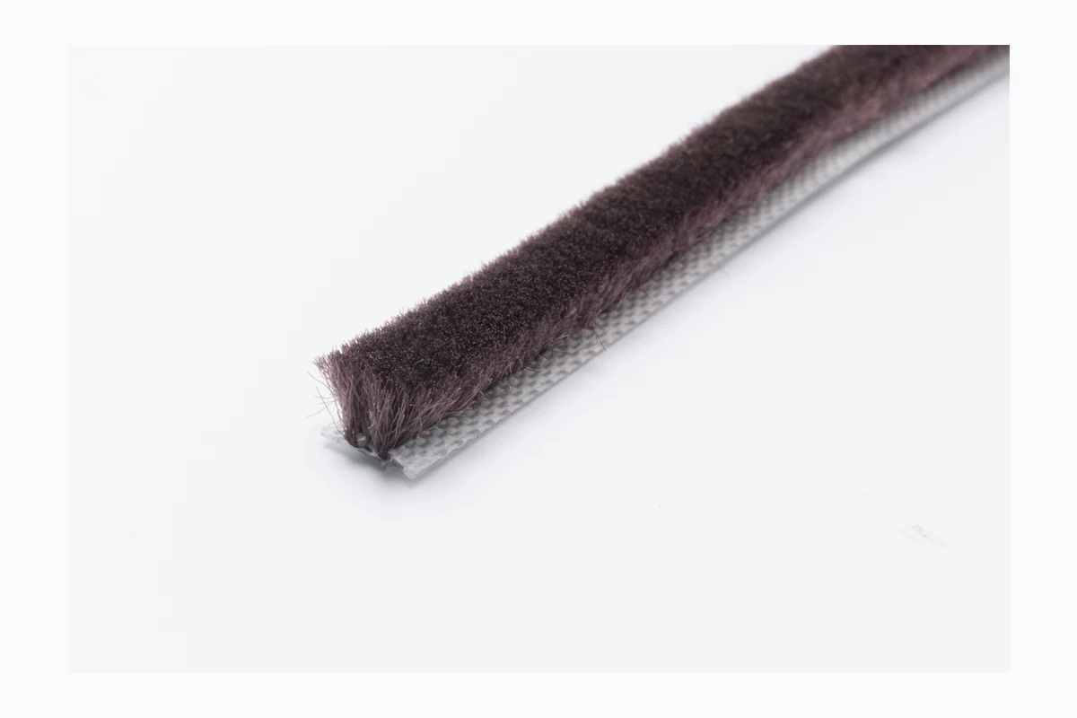 Dark brown regular wool pile weatherstrip for wooden doors and brown frames